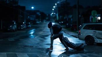 Culprits TV show screenshot 1: a man drags a heavy duffel bag away from a car accident