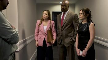 Cupertino TV show screenshot 2: Rachel Keller, Mike Colter, and Ella Stiller stand in a corridor.