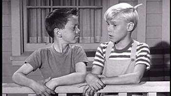 Dennis the Menace TV Show: Dennis and a friend lean on a fence