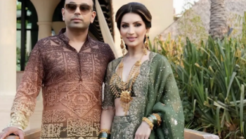 Desi Bling TV show screenshot 1: Satish and Tabinda Sanpal wearing styled Indian-inspired attire standing outdoors. 