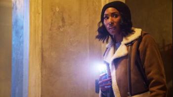 Diarra from Detroit TV Show Screenshot 3: Diarra Kilpatrick leaning forward with her phone flashlight on.