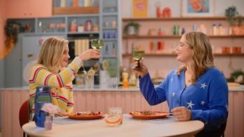Dish It Out TV show screenshot 3: Actress Gillian Jacobs and Ramsay sit at a table in front of their freshly-cooked meal, toasting each other.