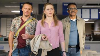 DMV TV show screenshot 1: (L-R) Tony Cavalero, Harriet Dyer, and Tim Meadows walk down a corridor of chairs. They carry bags and jackets.