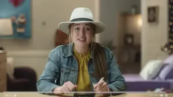 Dot Corner Webtective TV: Dot sits in her room in her fedora hat and denim jacket talking to the screen of her online vlog.
