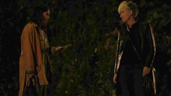 Down Cemetery Road screenshot 2: Ruth Wilson and Emma Thompson face each other outside in the night. Wilson holds out a letter to Thompson.