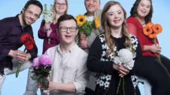 Down for love screenshot 1: A group picture of six cast members holding flowers. 