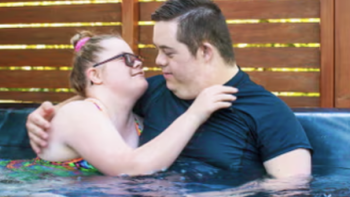 Down for Love screenshot 2: A man and a woman embracing in a hot spring. 