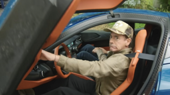 Downey's Dream Cars screenshot 4: Robert Downey Jr. grimaces sitting in Rimac Nevera. 