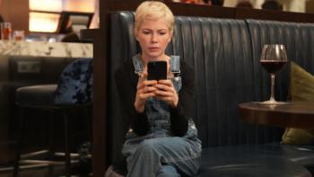 Dying for Sex TV show screenshot 1: Molly is center frame, looking at something on her phone in dismay