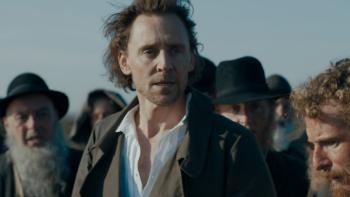 The Essex Serpent: Will stands in front of a crowd of men dressed in gray; they all appear distressed