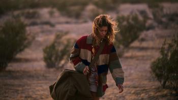 Euphoria Season 3: Rue is shown against a desert background, holding a duffel bag and appearing exhausted