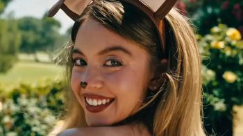 Euphoria Season 3: Cassie's face is shown in closeup; she has her face painted like a puppy and is wearing puppy ears and smiling