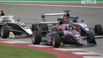 F1: The Academy TV show screenshot 1: A race car tails another race car during race. 