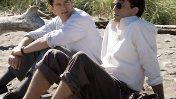 Fellow Travelers TV show screenshot 1: Hawks and Tim sit on the beach and talk. 