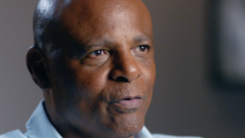 Field Generals TV show screenshot 1: Warren Moon in blue shirt talking. 