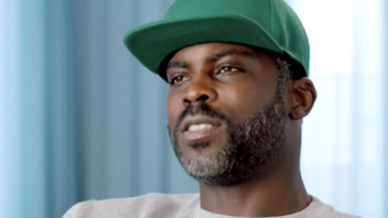 Field Generals TV show screenshot 2: Micheal Vick wearing a green hat. 