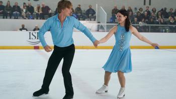Finding Her Edge: Brayden and Adriana hold hands as they execute moves on the ice; they wear matching skate costumes