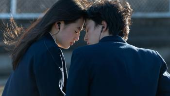 First Love TV show: A Japanese couple is seen listening to music together, they are sharing a pair of earbuds to listen to a song while they rest thei