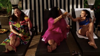 First Wives Club TV show screenshot 3: Bree sits on loungechair left of Hazel, who toasts with woman on right.  