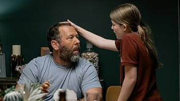 Free Bert TV show screenshot 2: Ila strokes Bert's head at the dinner table. 