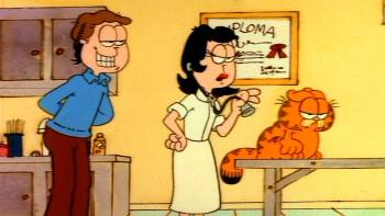 Garfield's Thanksgiving TV: Dr. Liz examines Garfield at the vet while Jon looks over her shoulder, willingly.