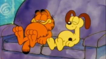 Garfield's Thanksgiving TV: Garfield and Oddie sit at a purple couch, their bellies full after Thanksgiving meal.