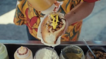 Garnachas: Glorious Street Food! TV show screenshot 1:Hands pour sauce on a Mexican street food snack. 