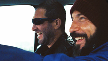 Gary TV show screenshot 1: Mikey and Richie in front seat of truck laughing, wearing sunglasses and a beanie.