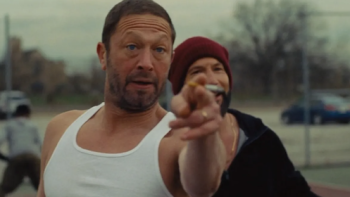 Gary TV show screenshot 2: Mikey in tank top gesturing forward while Richie in a beanie stands behind him.