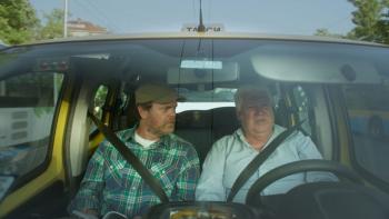 Rainn Wilson and the Geography of Bliss TV show: Rainn Wilson talks with another man in a car