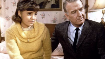 Gidget screenshot 2: Gidget and Professor Lawrence seated on a bed.
