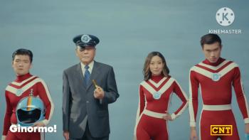 Ginormo: four people stand in a line, 3 of which are wearing matching red & white outfits.