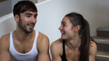 Glitter & Gold screenshot 3: Guillaume Cizeron and Laurence Fournier Beaudry sit on stairs laughing.