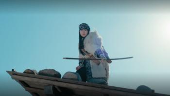 Golden Kamuy – The Hunt of Prisoners in Hokkaido – TV Show: Aspira stands holding a crossbow in front of a brightly lit sky