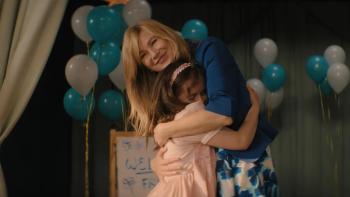 Good American Family TV show screenshot 2: Kristine Barnett hugs Natalia, who buries her face happily in her adopted mom's belly