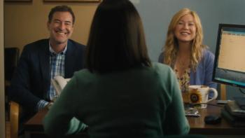 Good American Family TV show screenshot 3: Kristine and Michael Barnett are shown being interviewed in an office; both smile brightly