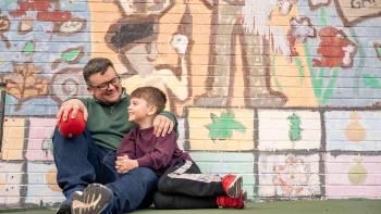 Grown Up Dad TV: dad Joseph Gidjunis hugs his son on a playground