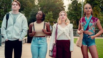 Heartstopper Forever TV show screenshot 3: Nick, Tara, Imogen and Elle, dressed casually, stand lined up across a road, staring at the distance