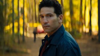 His & Hers TV show screenshot 1: Richard stands in front of a pine woods as yellow light filters through the trees; he looks to be disturbed