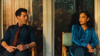 His & Hers TV show screenshot 2: Jack and Anna are seated in an office and looking at each other, discomfited by something