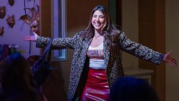 Hollywood Arts TV show screenshot 1: Daniella Monet wears a leopard print jacket, a red leather skirt, and a white tank top with the name “Trina!”.