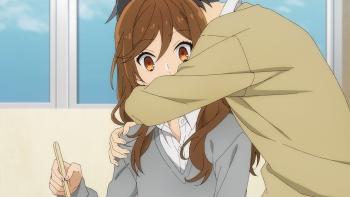 Horimiya: The Missing Pieces: Kyoko looks shocked as Izumi hugs her from the side.