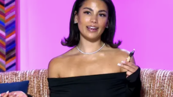 House of Heat TV show screenshot 2: Jade Ramey talks in black off shoulder dress against pink backdrop.