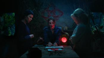 How to Get to Heaven from Belfast TV show screenshot 1: Robyn, Saoirse and Dara sit together at a table in a dim room