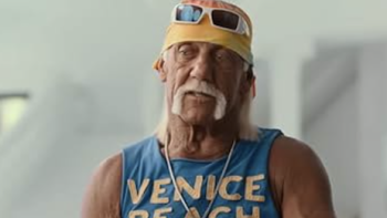 Hulk Hogan: Real American TV show screenshot 1: Hulk Hogan wearing yellow hat and blue shirt with yellow letters.