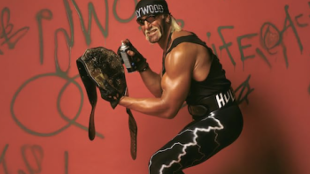Hulk Hogan: Real American TV show screenshot 2: Hulk Hogan wearing WCW black wrestling garb and spray painting wrestling belt. 