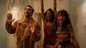 I Love LA TV show screenshot 1: Charlie, Alani and Tallulah stand together under a canopy of curling balloon strings, striking a festive pose