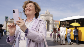 If It’s Tuesday, It’s Murder TV show TV show screenshot 2: Pura (Ana Wagener) takes selfie in front of yellow tour bus.