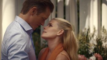 Imperfect Women TV show screenshot 2: Robert and Kate are outside against a white fence with faces close together, about to kiss