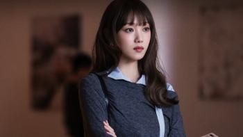 In Your Radiant Season TV show screenshot 2: Lee Sung-kyung stands in an art gallery. She wears a dark grey and light blue shirt.